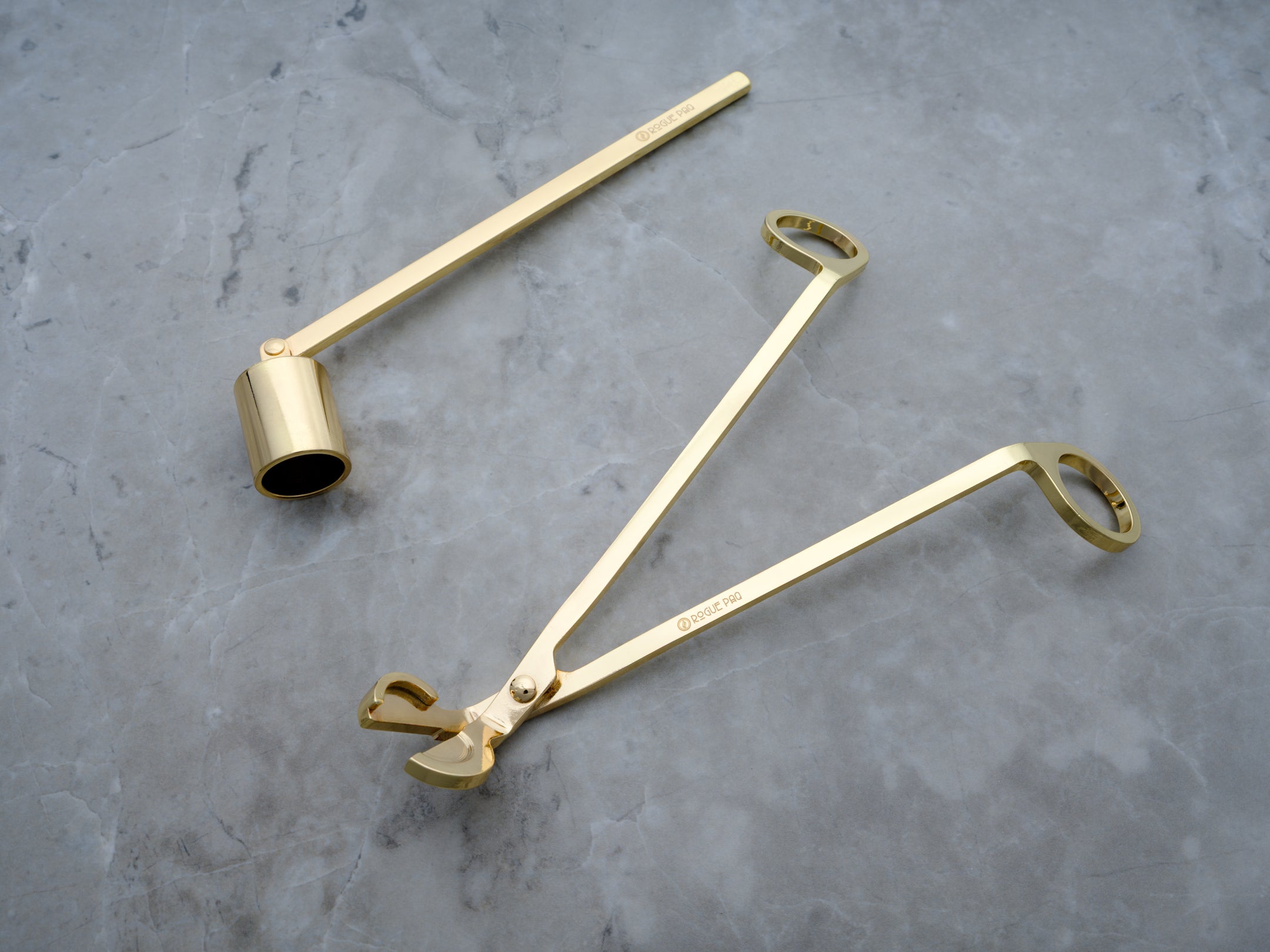 A luxury two-piece candle care set in a high-polish gold finish. The set includes a wick trimmer amd a candle snuffer with a pivoting head all featuring sleek, ergonomic handles and a minimalist, luxury aesthetic. Perfect as a hostess gift.