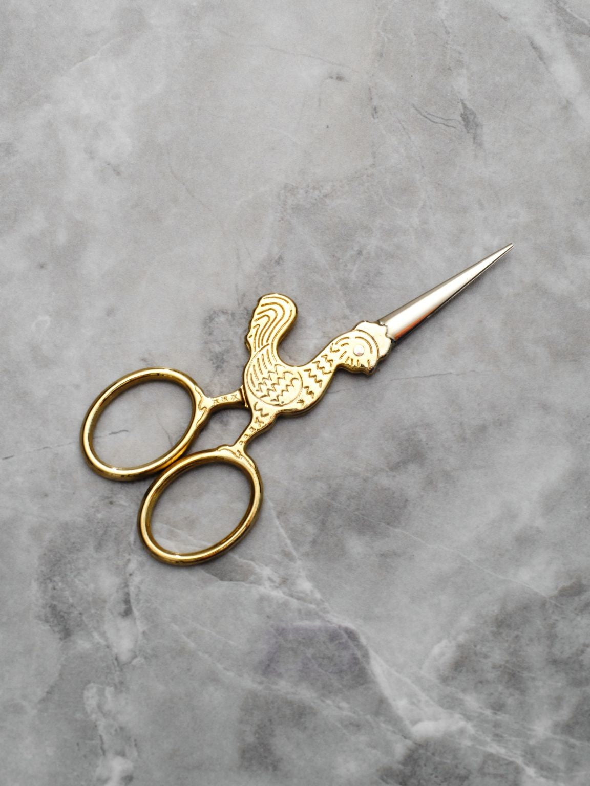 Small utility scissors with a whimsical rooster design make your ritual lighter and more fun.