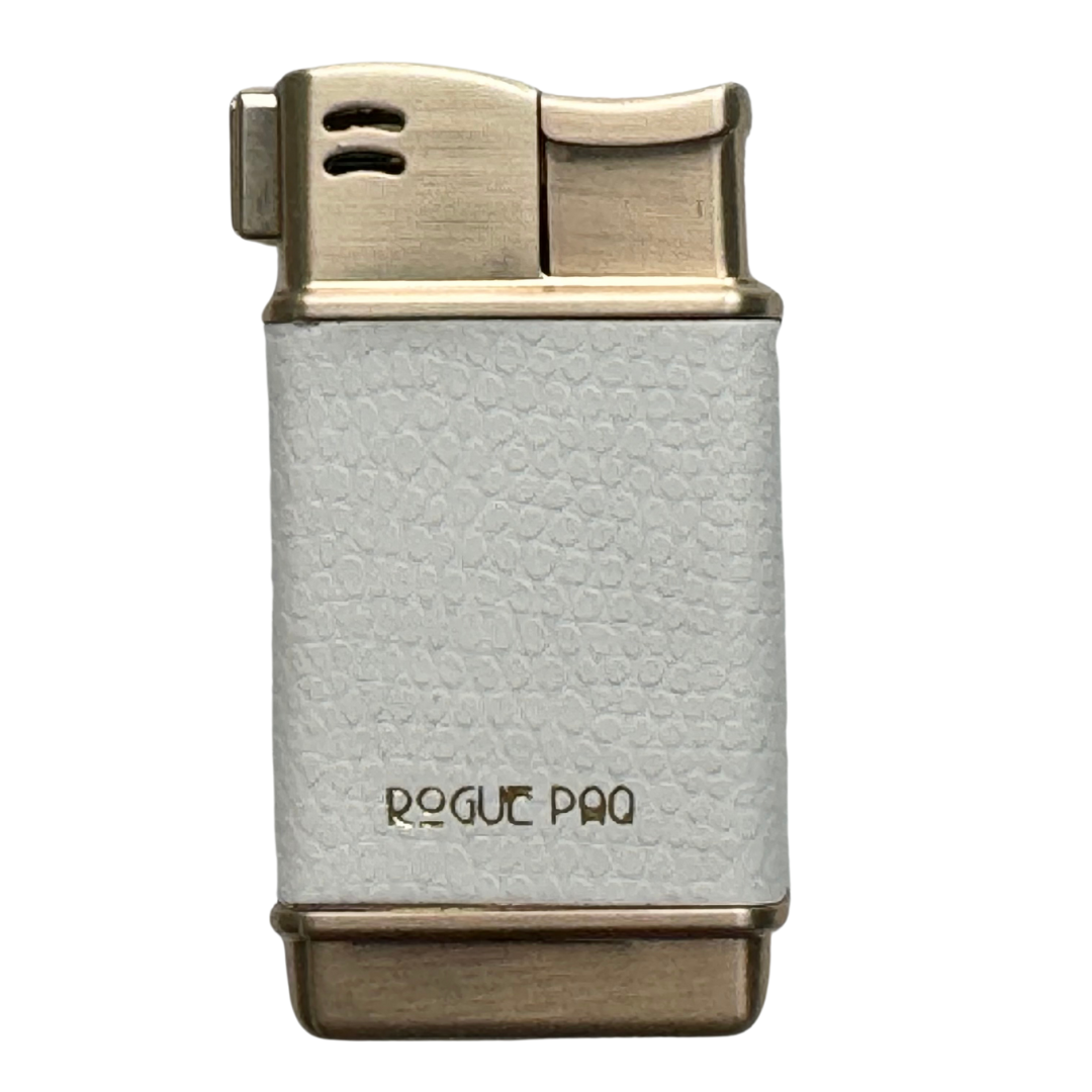 The Rogue Paq refillable lighter in Cream. A minimalist and chic ivory-colored lizard- textured wrap sits atop a gold-tone metal casing. This neutral accessory is designed for the sophisticated smoker who values a clean aesthetic