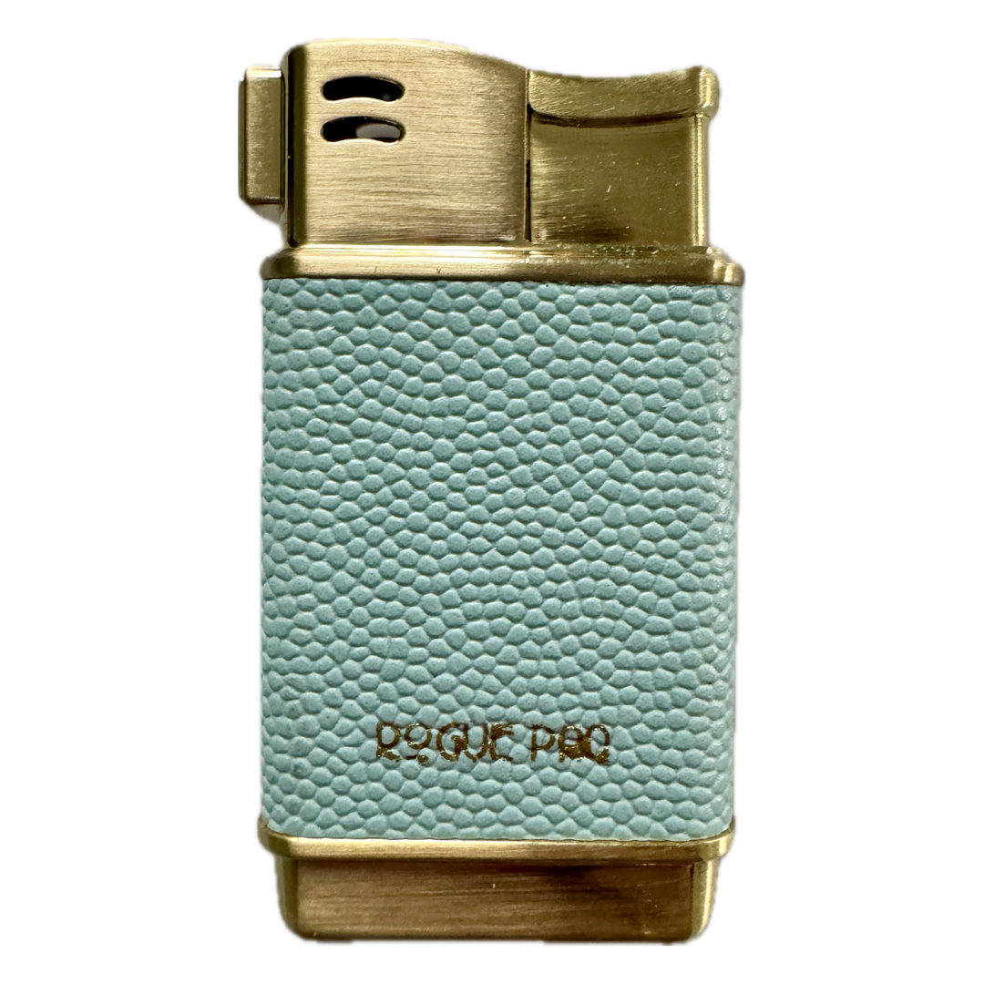 Rogue Paq refillable butane lighter in soft sky blue. This forever lighter features a gold-tone finish and high-quality vegan skin, bringing a subtle pop of color to the luxury cannabis ritual.