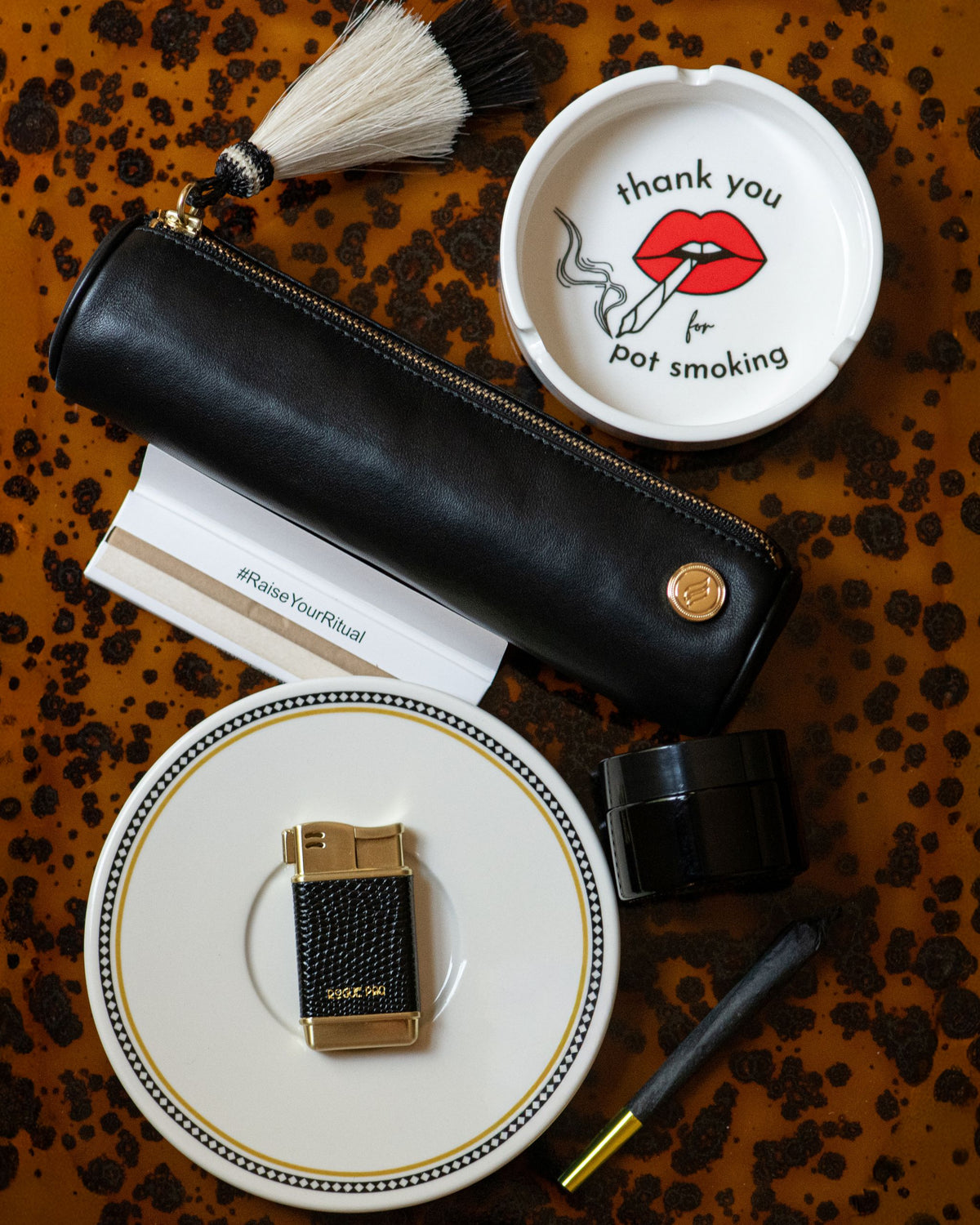 Solo Paq with the Thank You ashtray, black vegan lizardskin lighter, uv jar, cones, and papers.