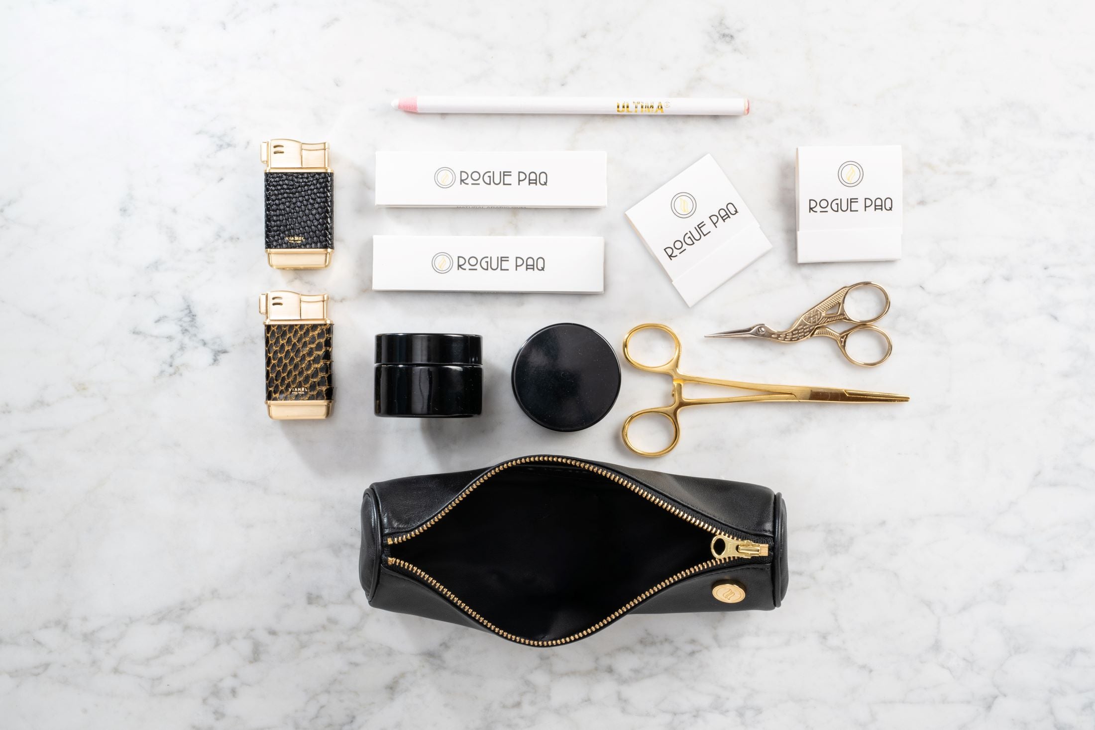 Open Solo Paq cannabis case in supple lambskin leather displaying organized gold tools and accessories; a compact and scent-suppressant solution for the modern smoker.