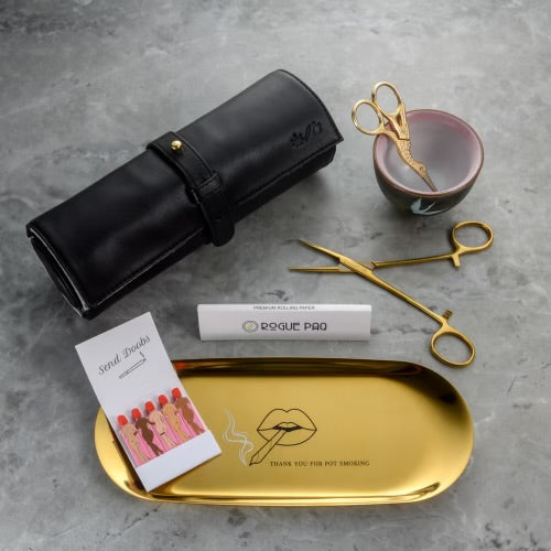 Crane bud snipping set styled for a slow-ritual session; showcasing the tactile experience of hand-snipping flower with premium gold tools and artisan ceramics. Shown here with the Rogue Paq Thank You for Pot Smoking Rolling Tray, gold hemostat packing tool and clip, premium king slim rolling papers, Send Doobs matches, and lambskin Ritual Case.