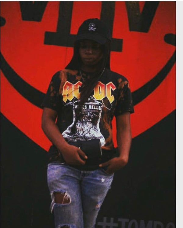 Woman with hands in pocket, AC/DC shirt