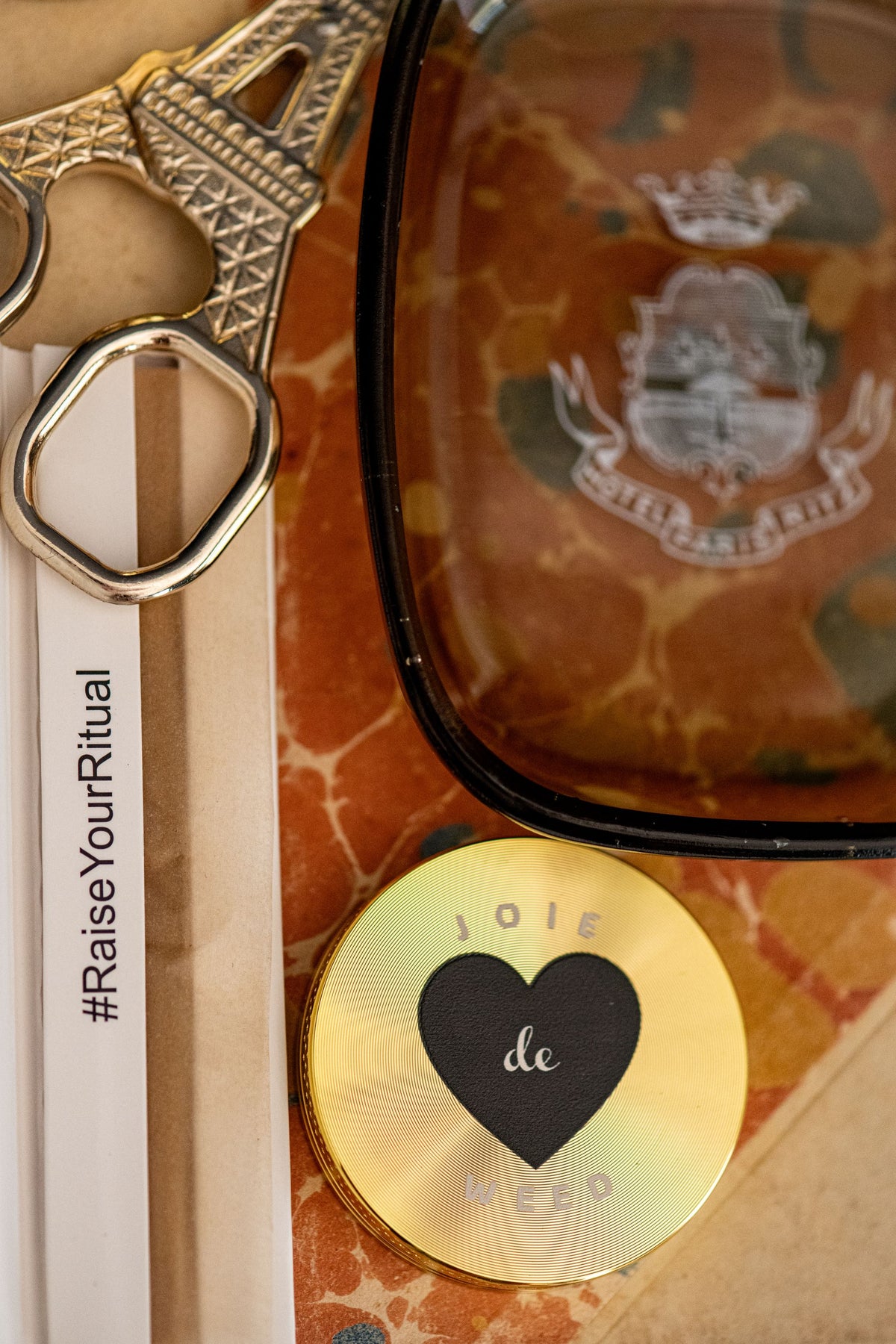 Close up of our 50mm Joie de Weed Grinder with our hemp papers and Eiffel Tower Scissors