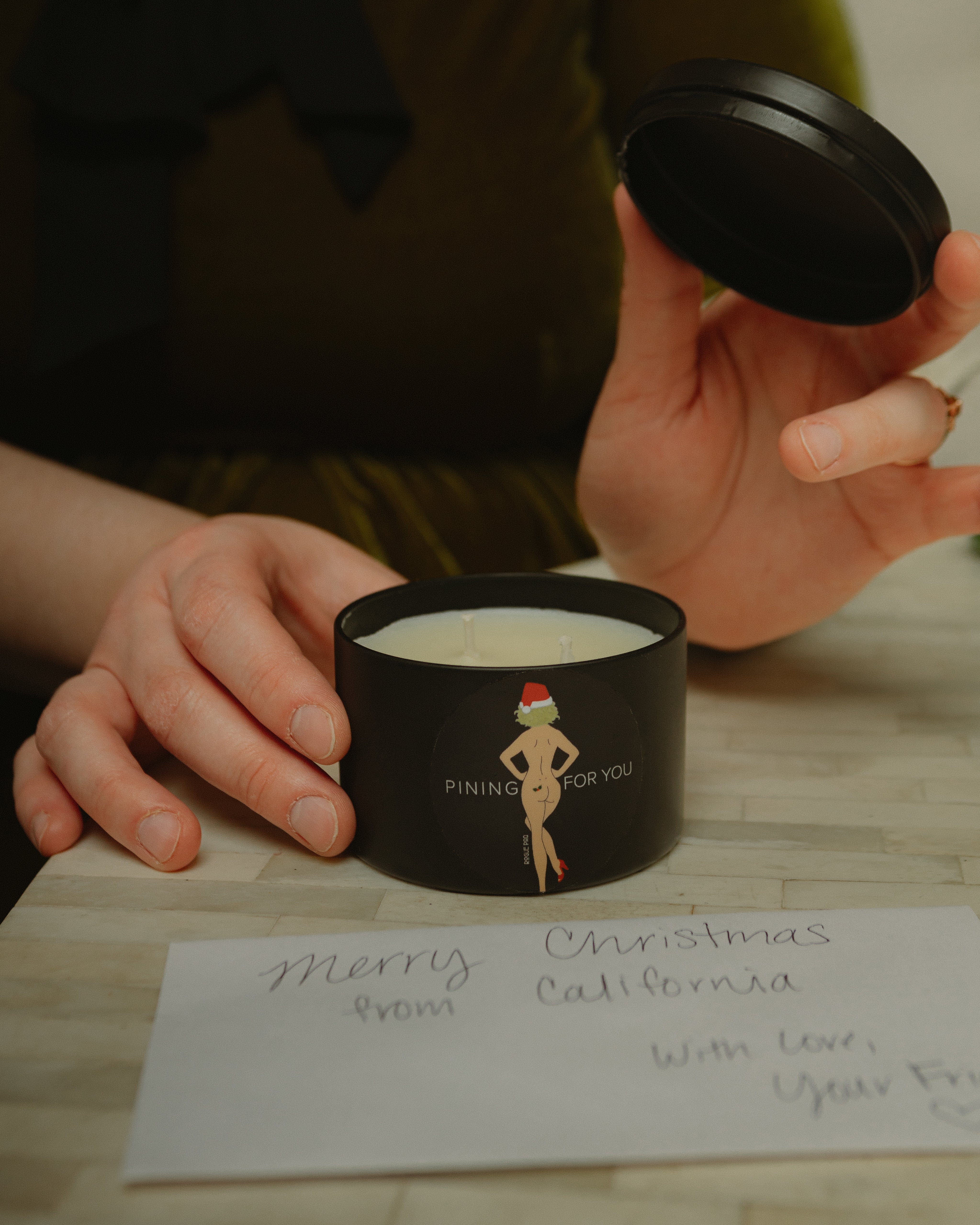 Top view of the 'Pining For You' candle showing the matching lid; designed to preserve the scent and allow the tin to be reused as a discreet stash jar after burning.