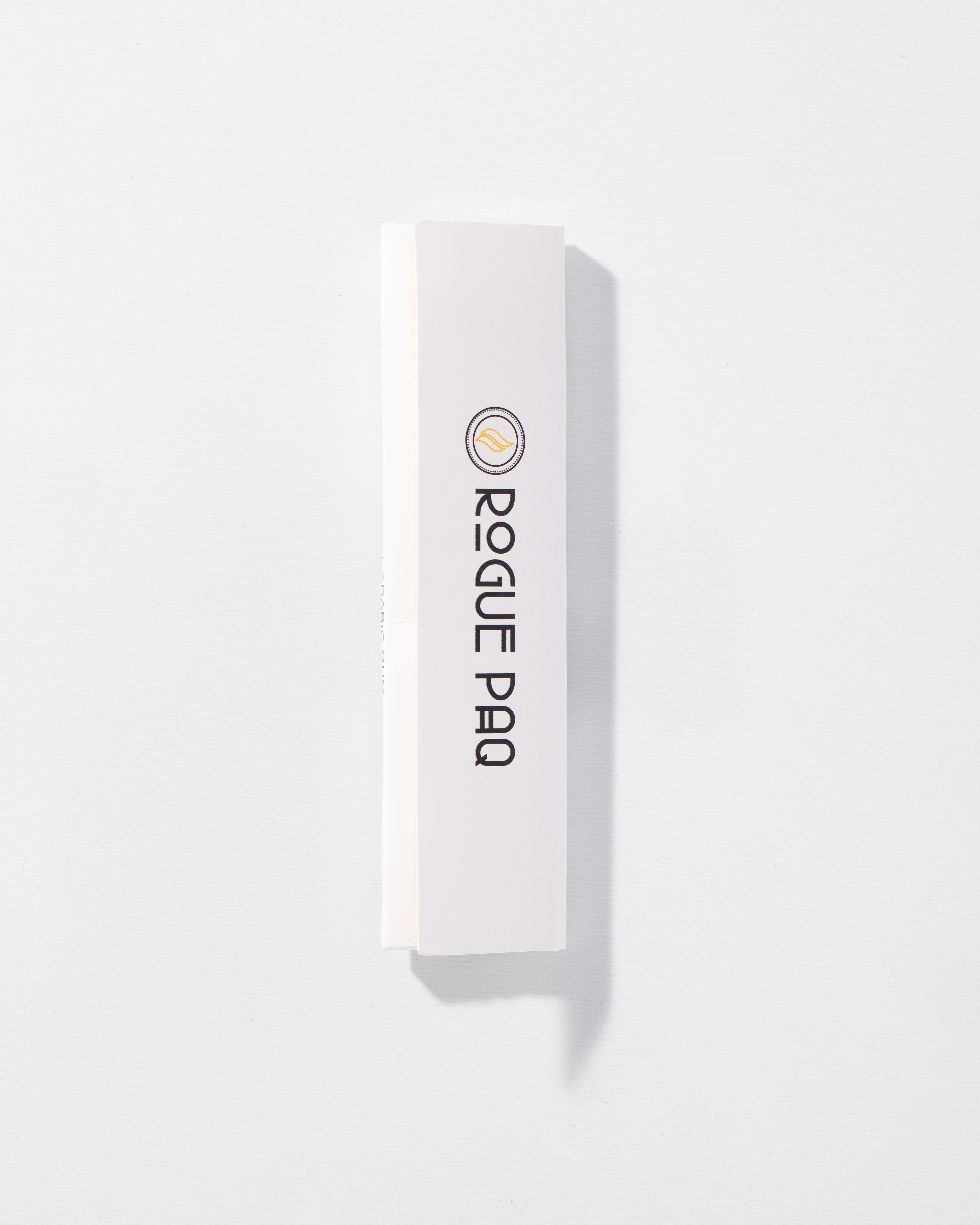 Front view of the closed Rogue Paq rolling paper booklet. The high-contrast design features the 'Rogue Paq' logo in a sophisticated serif font. The clean, professional packaging reflects the brand's 'Raise Your Ritual' philosophy.