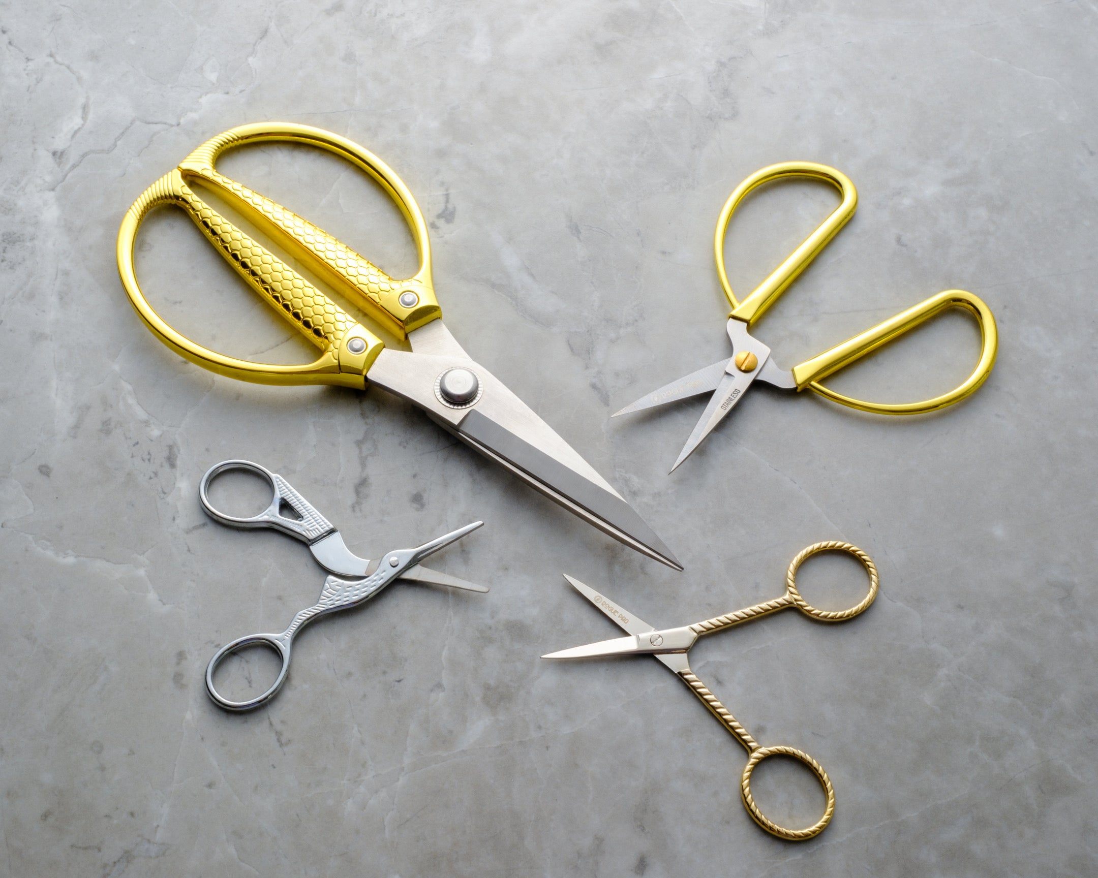 Rogue Paq bonsai gardening scissors with XL snake handle scissors, ribbon wrapped scissors, and silver crane scissors. All are stylish and functional tools designed for the modern cannabis connoisseur