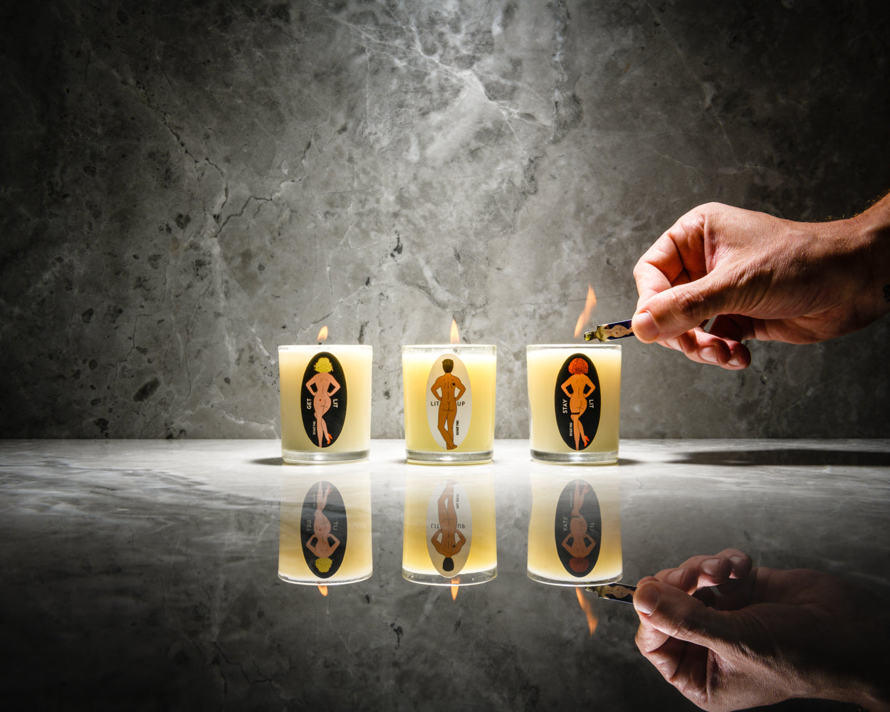 The trio of massage candles in the Cann-Canndle Gift Set is presented in a clean, high-contrast style that emphasizes the brand's 'Raise Your Ritual' philosophy of aesthetic and functional cannabis accessories. These candles provide aromatherapy and massage therapy. They are part of the lineup of cute smoking accessories.