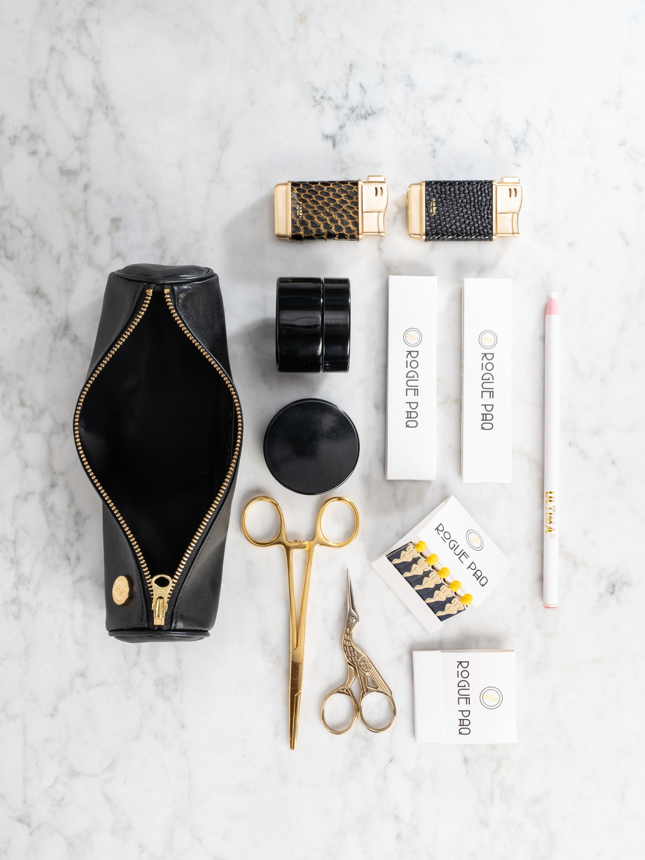 Rogue Paq Mini Ritual Gift Set featuring a lambskin leather Solo Paq; curated with gold-tone hemostats, crane scissors, and UV glass storage for a complete, luxury cannabis experience