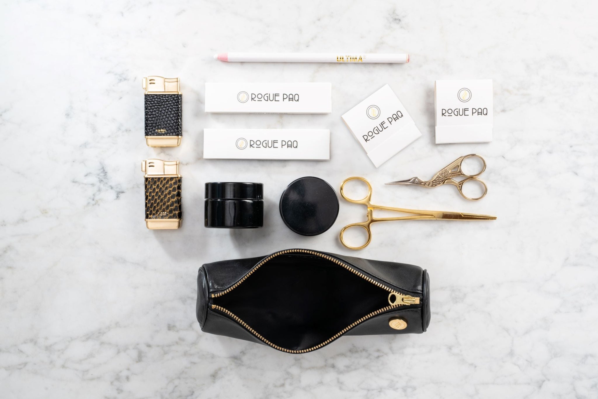 Open Solo Paq cannabis case in supple lambskin leather displaying organized gold tools and accessories; a compact and scent-suppressant solution for the modern smoker.