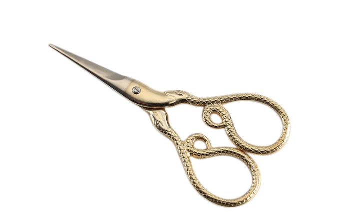 A pair of luxury precision trimming scissors featuring a unique python-skin texture on the gold-toned handles. The surgical-grade stainless steel blades are slender and sharp, designed for the fine-tuning of cannabis flower and hand-rolled joints.