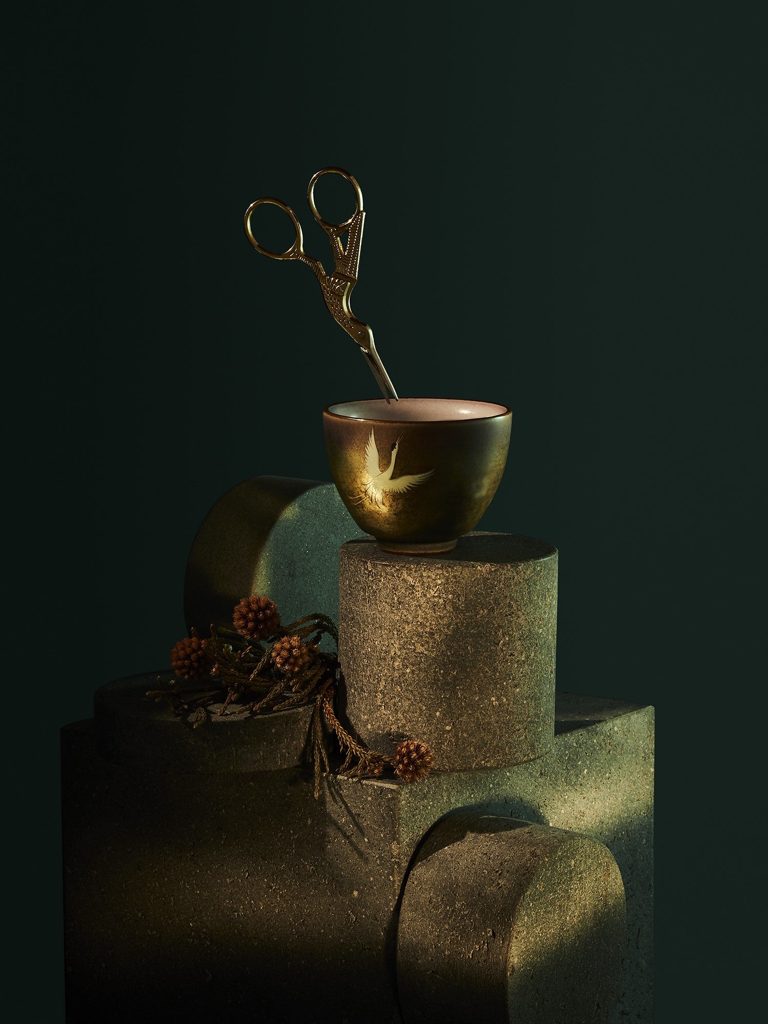 Stoneware ceramic snipping cup featuring an elegant crane motif; a 3oz vessel designed to hold cannabis flower during the manual grinding process. The cup comes with Gold stainless steel crane scissors with intricate crane design; precise 3.5-inch blades designed for manually trimming and snipping cannabis buds to a fluffy consistency.