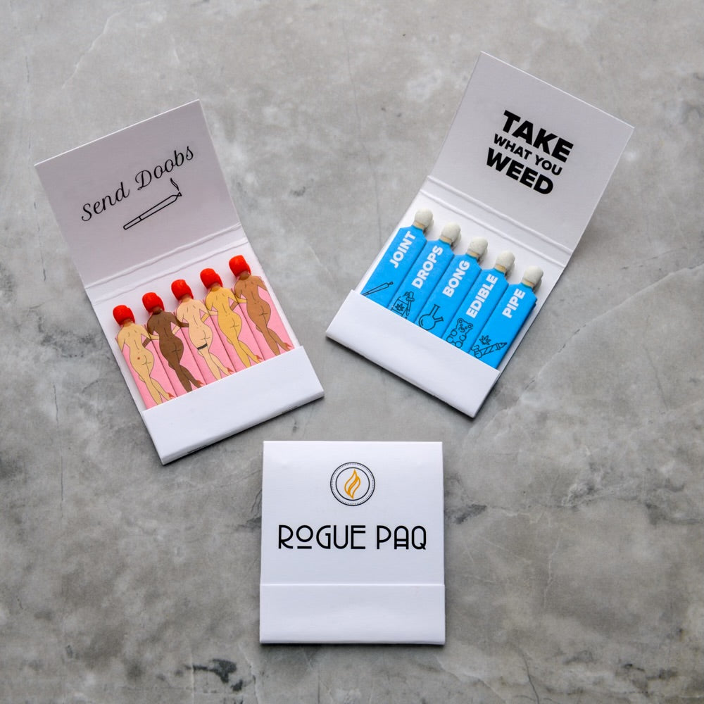 Close-up of Rogue Paq safety matches with the 'Take What You Weed' cover art; a thoughtful and functional accessory designed to bring intention to your smoking session. Styled with Send Doobs matches.